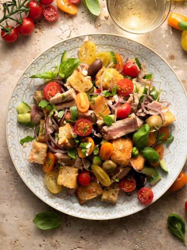 An overhead shot of a tuna panzanella salad on a large plate